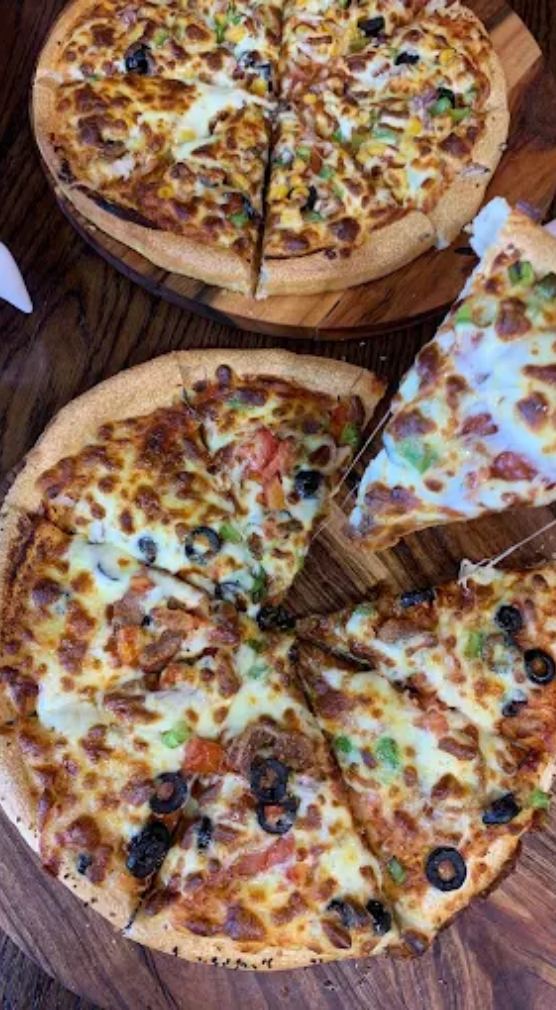 Freshly cut Bee Pizzeria pizzas